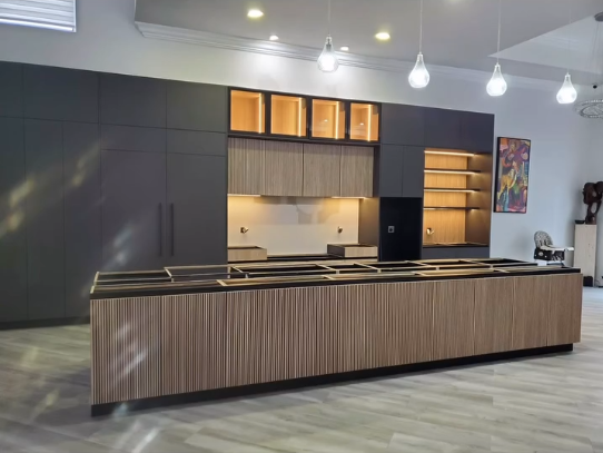 Luxury charcoal kitchen design with fluted island, built-in coffee station, and teardrop pendant lighting.